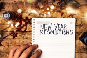 person-writing-new-year's-resolutions